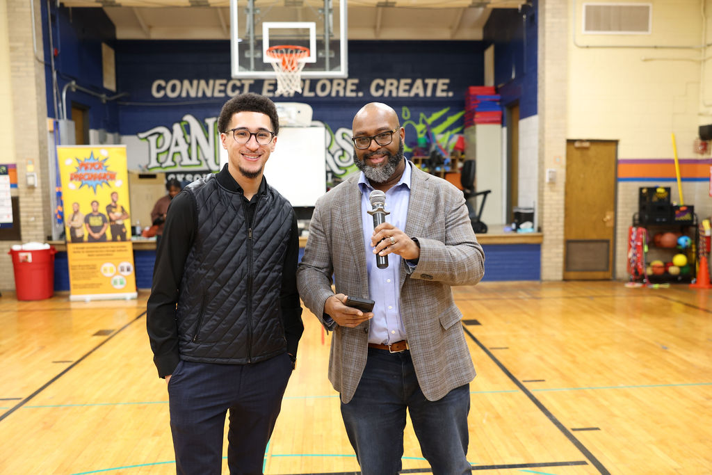 TC Bell speaking to a youth audience with microphone in hand
