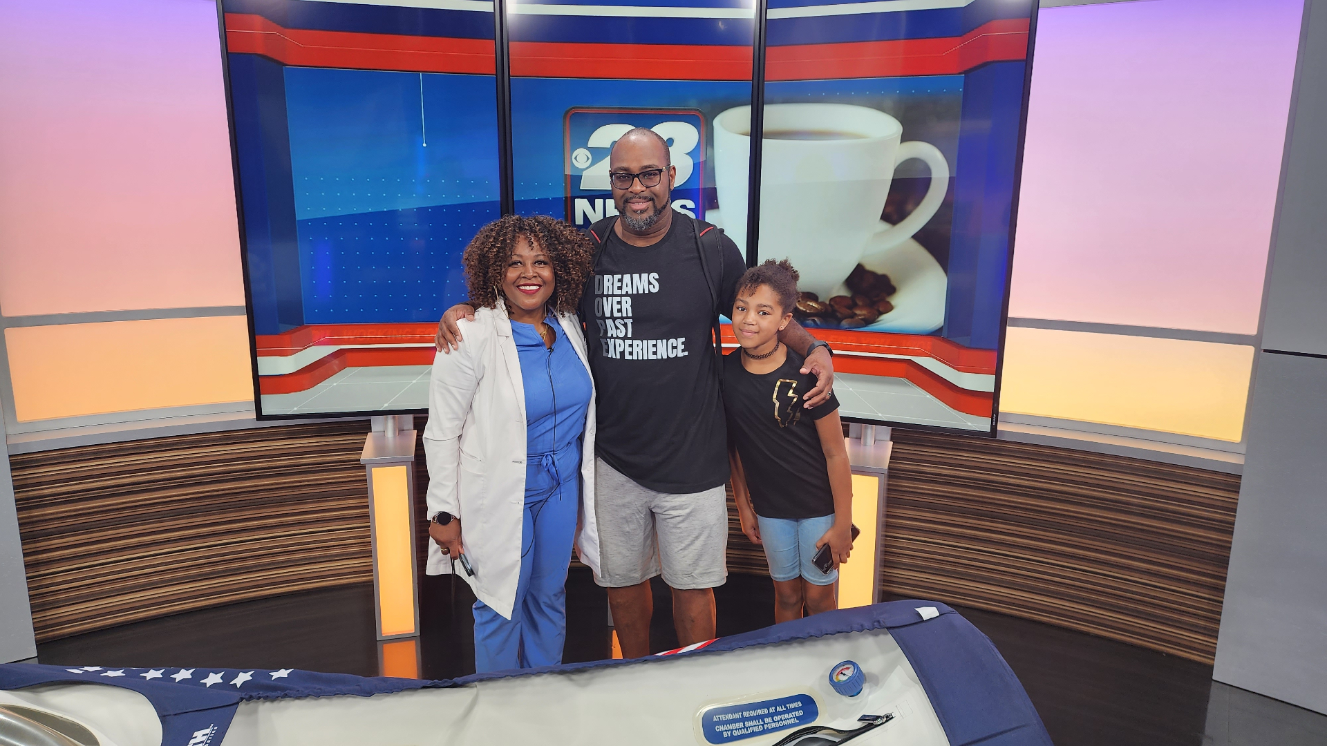 TC Bell in a television studio with colleagues and family
